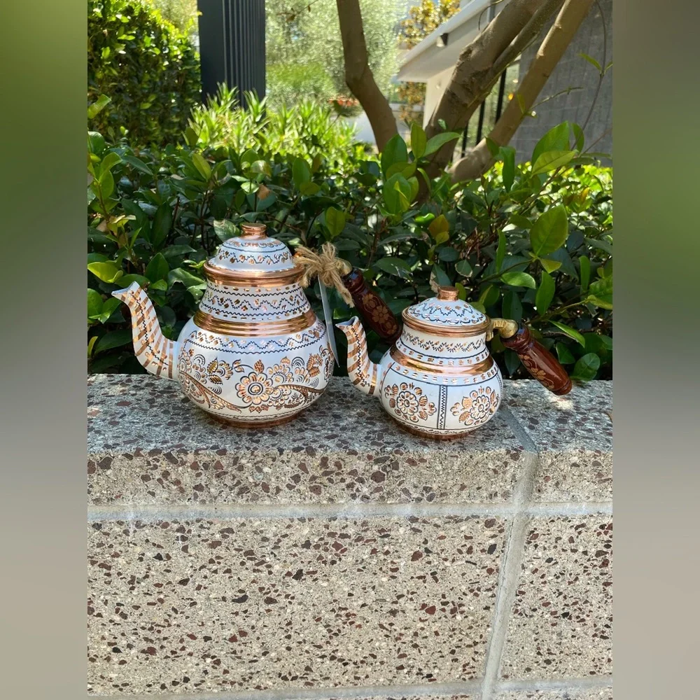 This handmade, white-painted Turkish copper teapot set features traditional